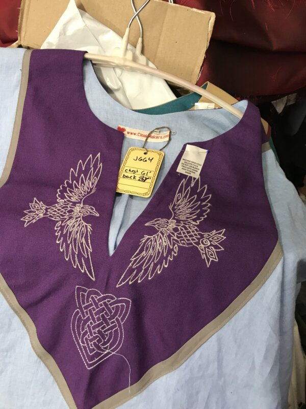 J664 - Light Blue Short Sleeve Linin Tunic, Purple Yoke w/Ravens & Heart Knot Embroidery, Grey Trim